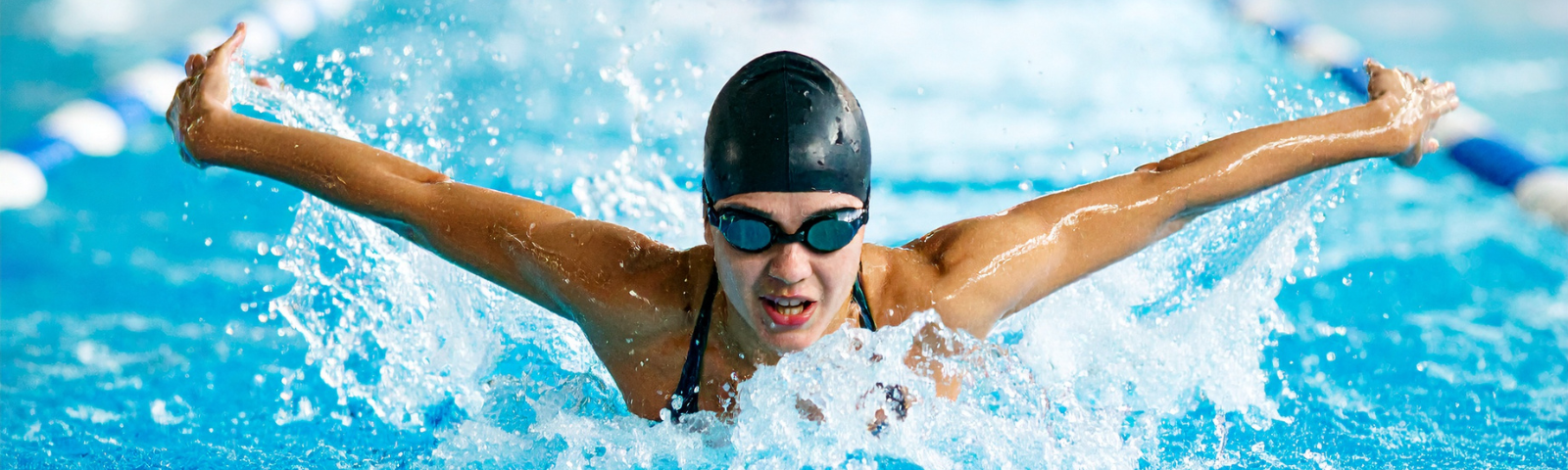 Swimmer in the pool with goggles and a swim cap.